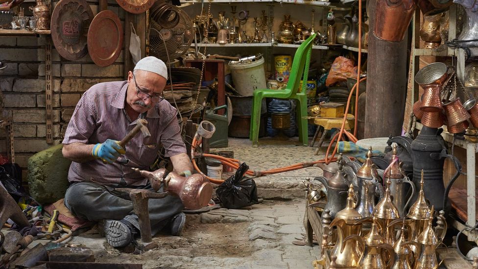 Al-Saffar is a fifth-generation coppersmith who works in a millennium-old souq (Credit: Simon Urwin)