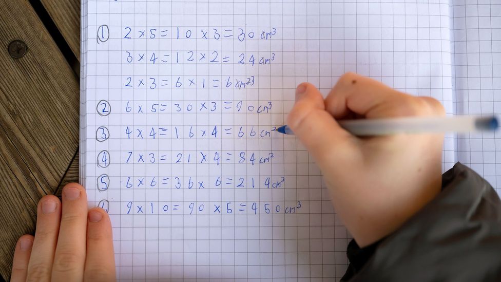 A primary school child in Cardiff, Wales, writes down maths excercises (Credit: Getty Images)